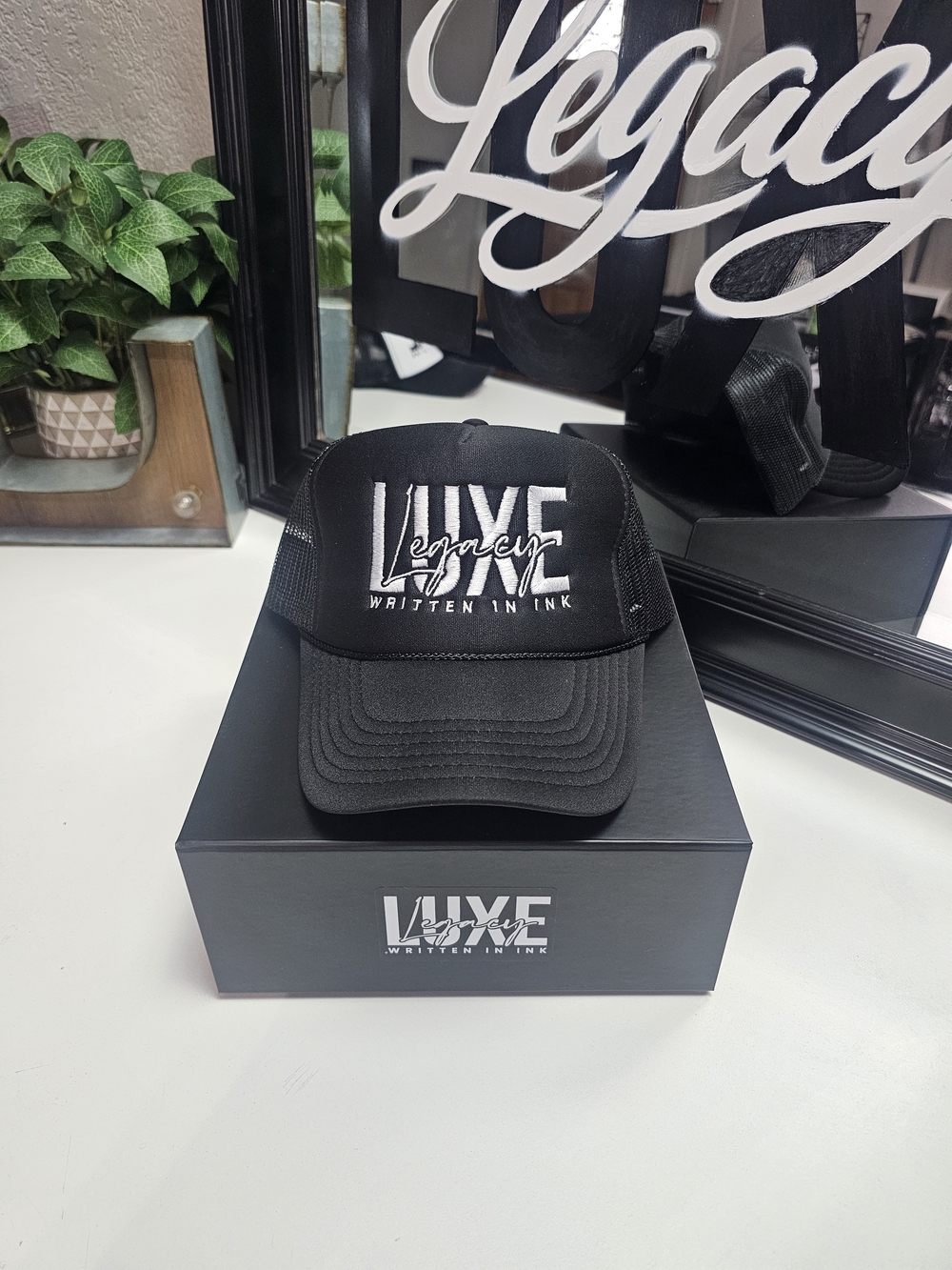 Luxe Legacy Black Trucker Hat with White Embroidered Logo